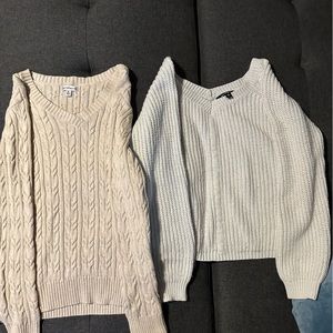 Two cream sweaters